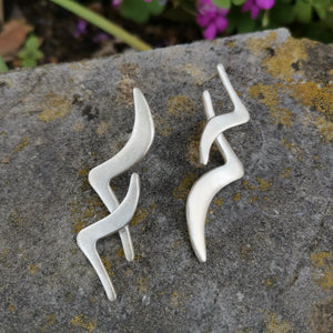 Handmade silver earrings. Two silver birds flying together.